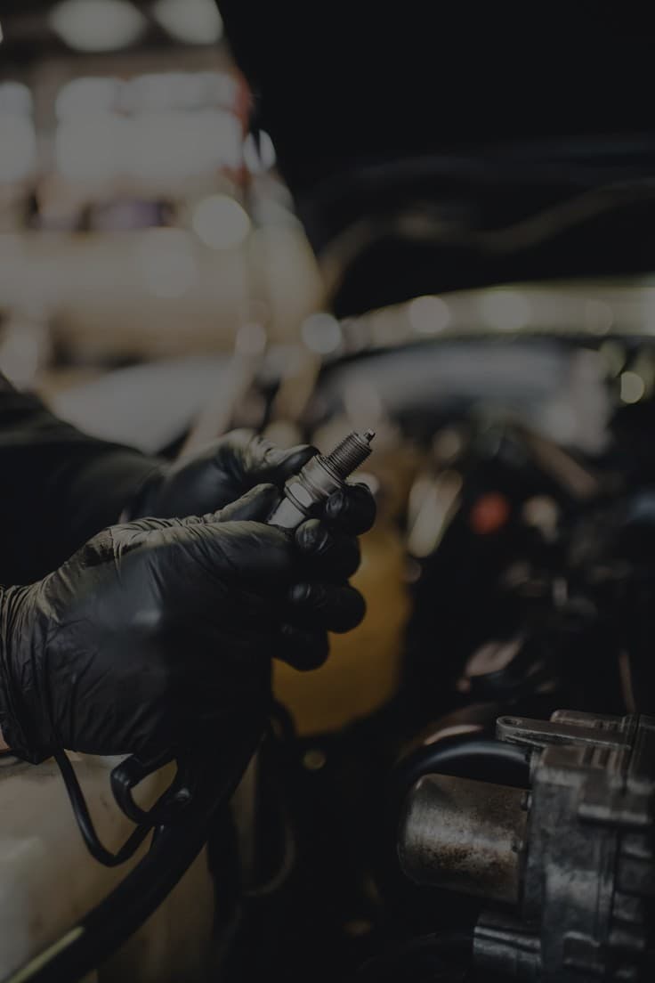 Technician servicing an engine bay